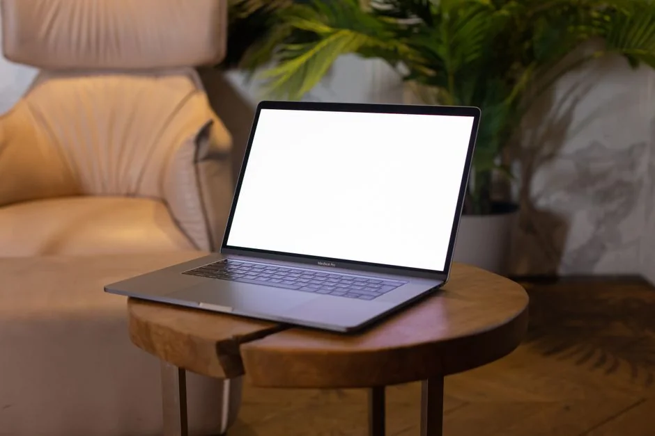 A woman examining a brand strategy document on a clipboard next to a laptop in an office setting.